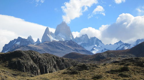 Scenic view of mountains against cloudy sky