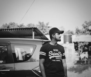 Young man wearing cap while standing outdoors