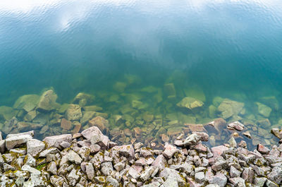 High angle view of rocks at lakeshore