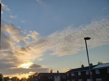 Low angle view of street light and building against sky