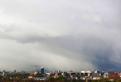 Cityscape against cloudy sky