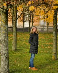 Full length portrait of man standing in park during autumn