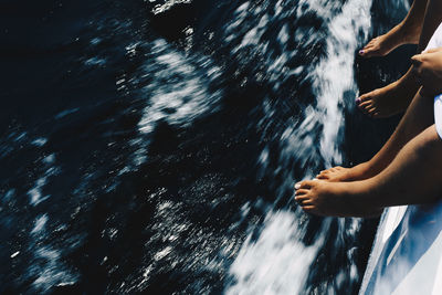 Low section of man and woman in boat over sea