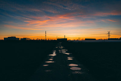 Silhouette buildings against sky during sunset