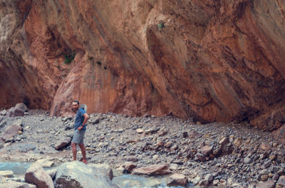 Full length of man standing on rock