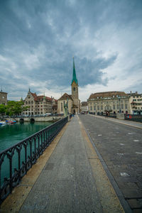 Canal amidst buildings against sky in city