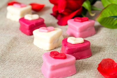 Close-up of heart shape on pink cake