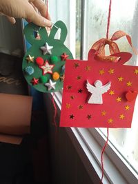 Cropped hand of woman holding christmas presents