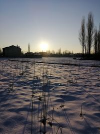 Scenic view of frozen lake against sky during sunset