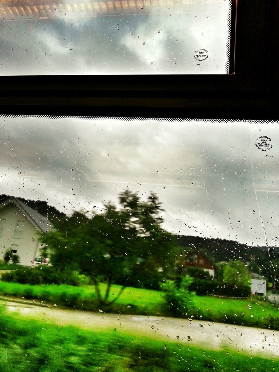 window, drop, indoors, wet, transparent, water, glass - material, rain, sky, weather, raindrop, glass, built structure, season, architecture, looking through window, building exterior, monsoon, cloud - sky, rainy season