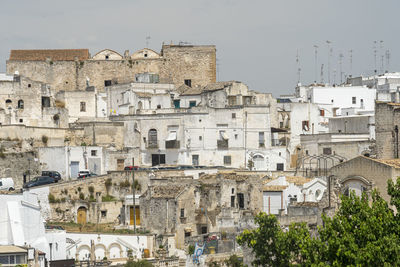 Buildings in town against sky