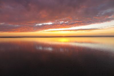 Scenic view of sea against romantic sky at sunset