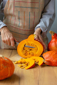 Midsection of man holding pumpkin