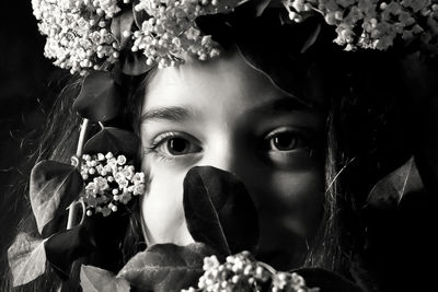 Close-up of young woman with flowers