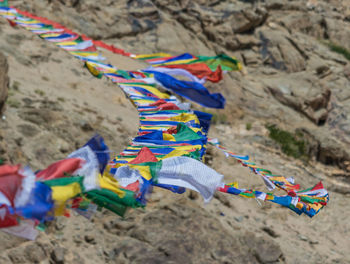 High angle view of multi colored umbrellas hanging on sand