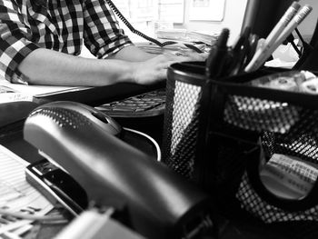 Midsection of woman using computer at table