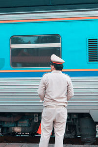 Rear view of man standing at train