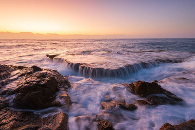 Scenic view of sea against sky during sunset