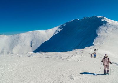 Scenic view of snow covered mountains against clear sky