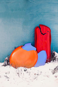 Close-up of snow covered land against wall