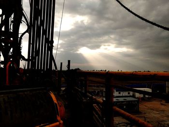 Metallic structure against sky during sunset