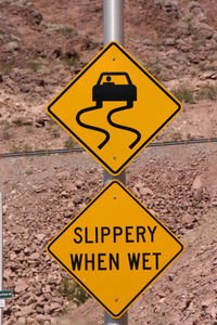 Warning sign against rocky mountain