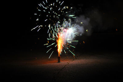 Night-time shot of fireworks in street.