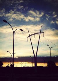 Low angle view of street light against cloudy sky