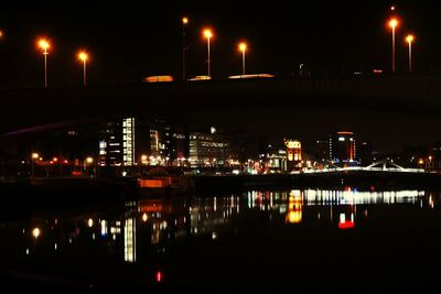 Illuminated city against sky at night