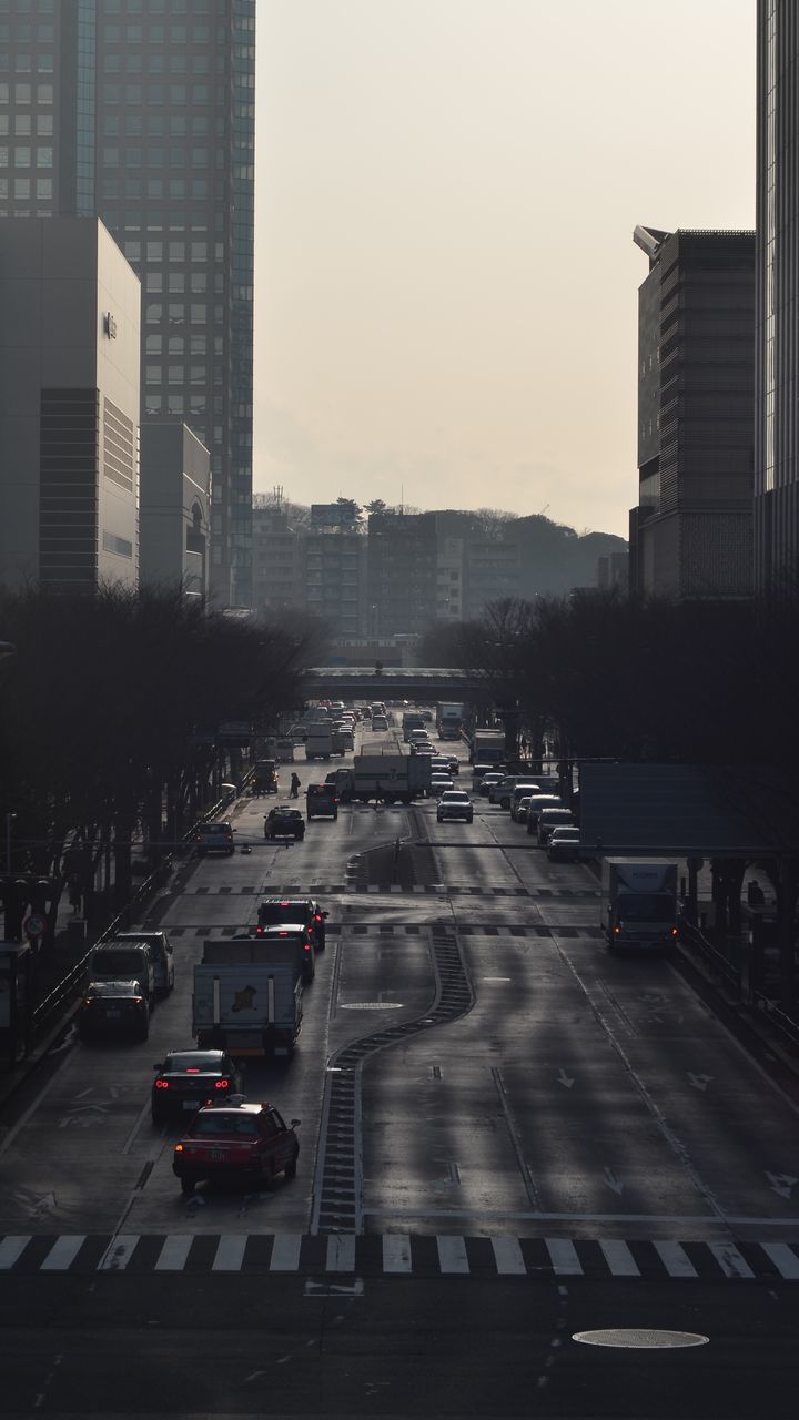 city, car, transportation, architecture, building exterior, traffic, land vehicle, built structure, city life, no people, travel destinations, yellow taxi, road, sunset, skyscraper, day, outdoors