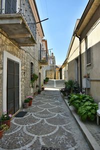 A narrow street among the old houses of greci, a village in the campania region, italy.