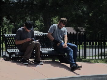 Young man sitting in park