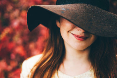 Portrait of young woman wearing hat