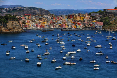 High angle view of townscape by sea against sky