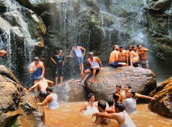 People enjoying at waterfall