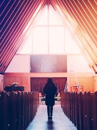 Full length rear view of woman in church