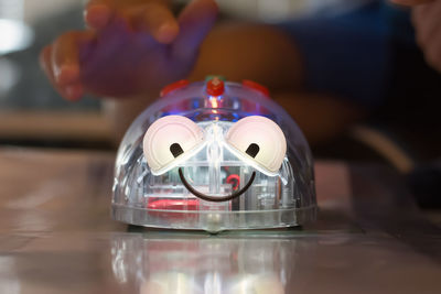 Close up of robot, kid testing his robot in a programing camp, smiling