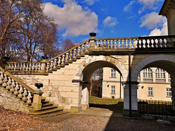 Bridge by building against sky