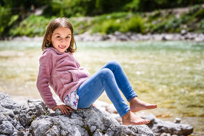 Portrait of smiling girl on rock