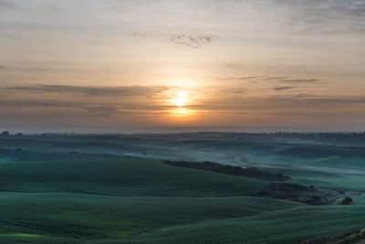 Scenic view of landscape against sky during sunset