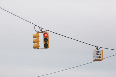 Low angle view of road signal against sky