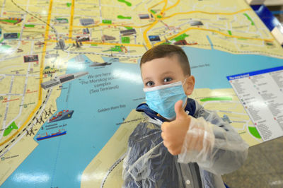 Portrait of boy holding umbrella