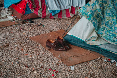 A pair of shoes near a homeless' tent 