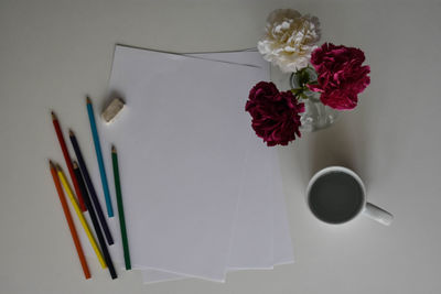 High angle view of white roses on table