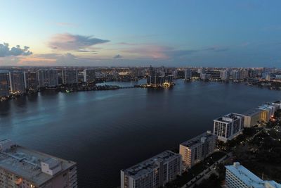 High angle view of buildings by sea against sky