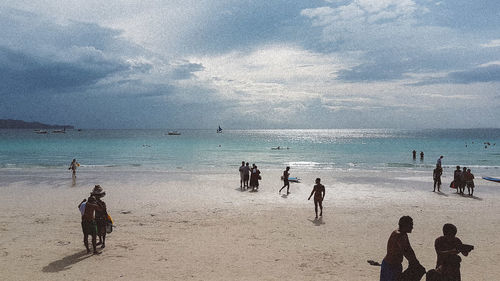 People on beach against sky