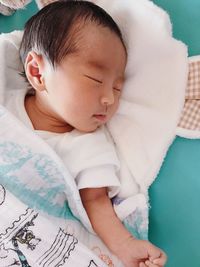 High angle view of baby sleeping