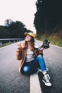 Young woman sitting on road