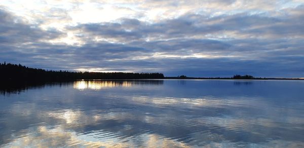 Scenic view of lake against sky at sunset