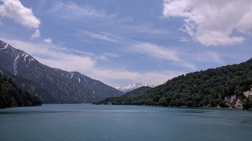 Scenic view of lake and mountains against sky